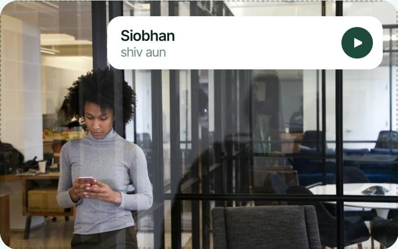 A woman looking up a name on her phone in an office